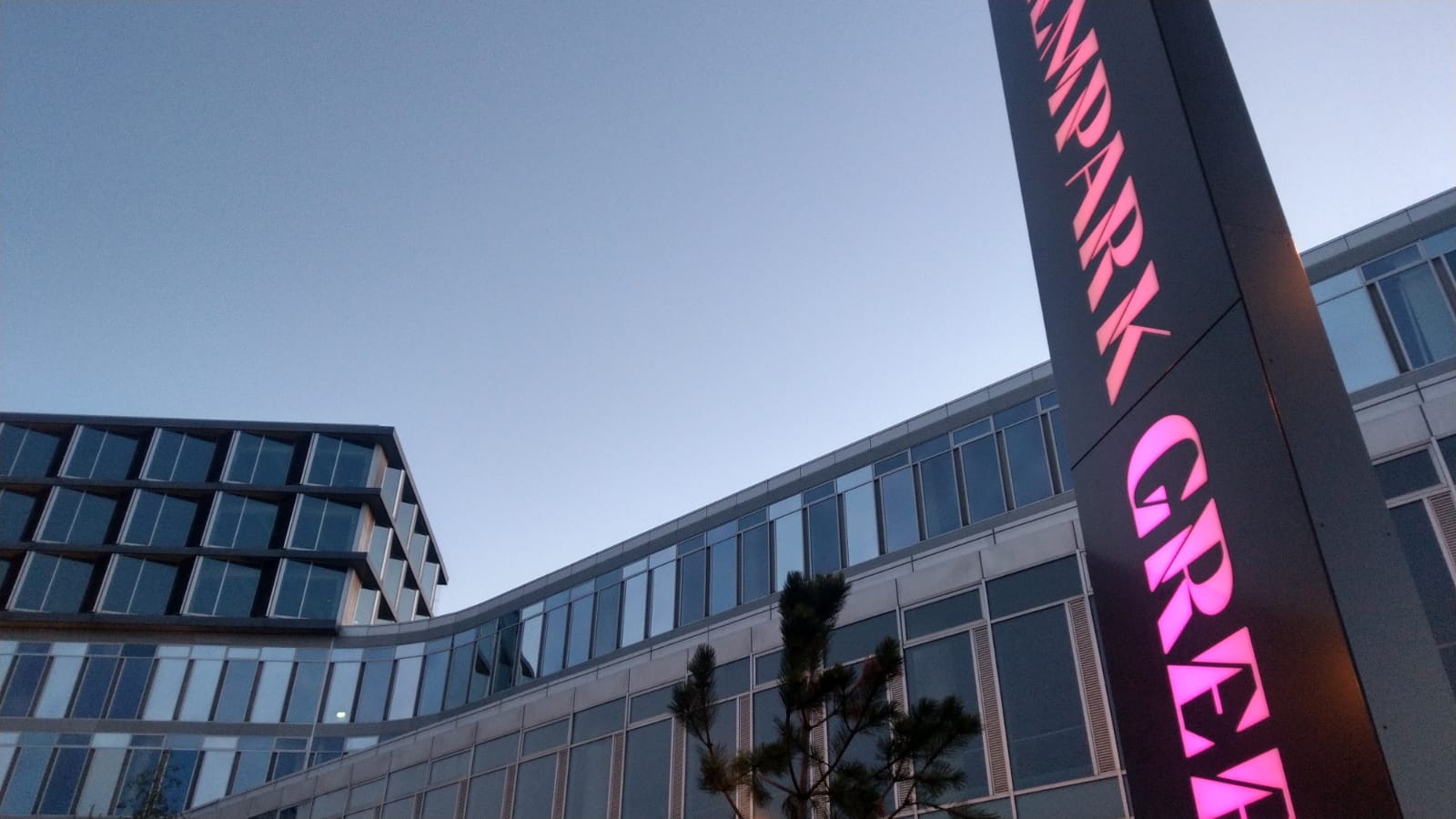 The illuminated Elmpark Green sign at dusk